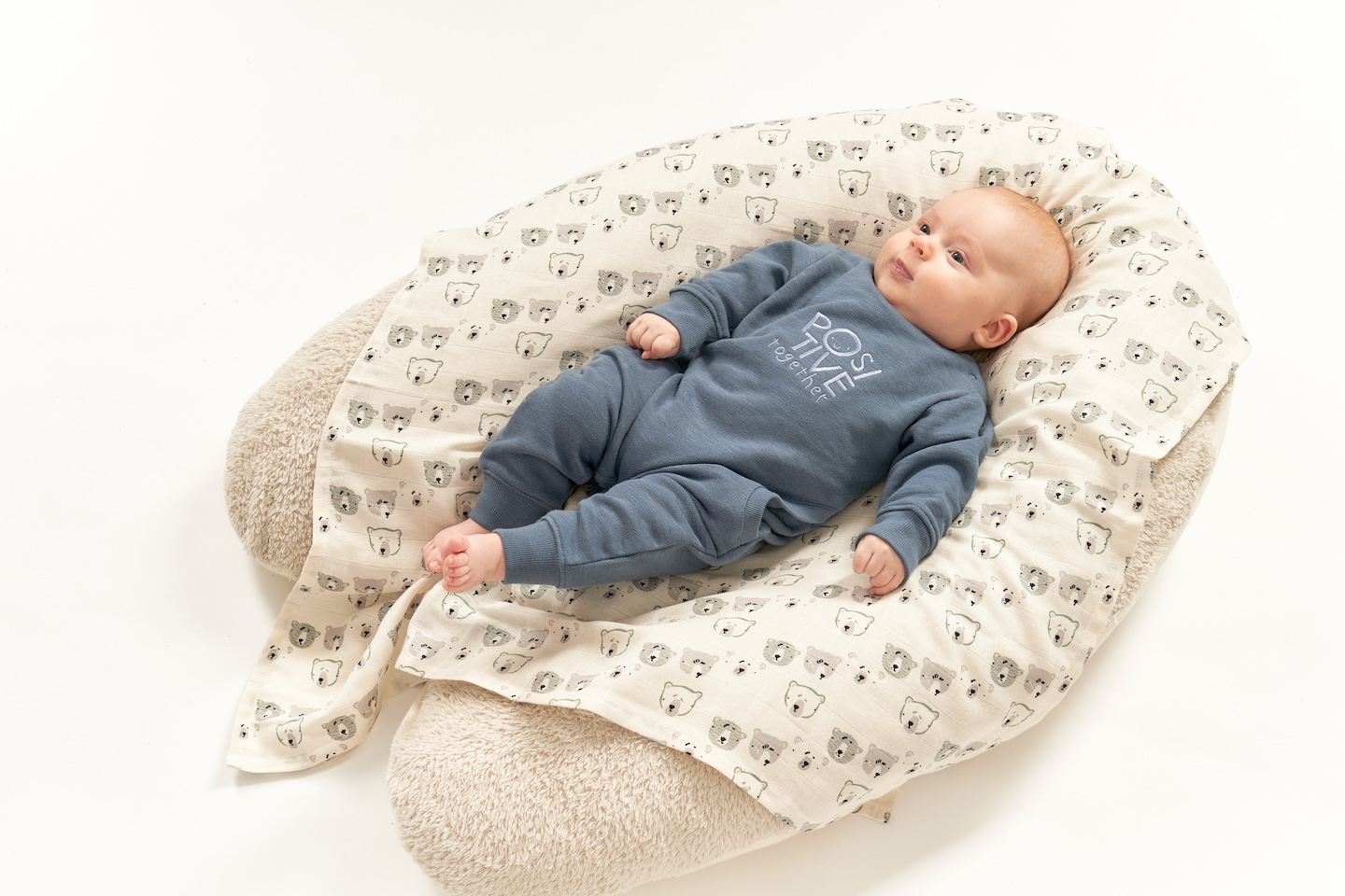 Baby liegt auf großem Kissen